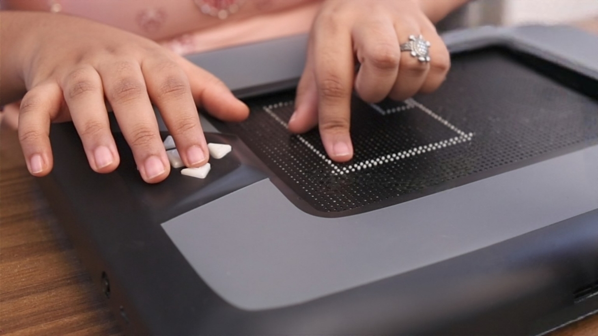 Students using uDot tactile display for STEM learning